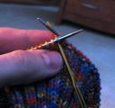 sewing needle in through first knit stitch