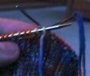 sewing needle in through first purl stitch