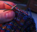 sewing needle out through first knit stitch