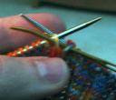 sewing needle out through second knit stitch