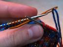 take second purl stitch off knitting needle