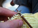 Slip stitch back onto resting needle and knit stitch