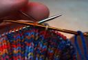 sewing needle out through first knit stitch of next rib